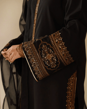 Black abaya with intricate gold embroidery and sequins on sleeves and trim