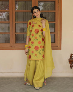 Woman in yellow shalwar kameez with red floral embroidery and matching dupatta