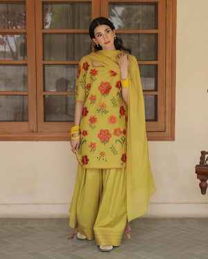 Woman in yellow shalwar kameez with red floral embroidery and matching dupatta